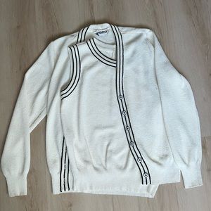 Two piece white cardigan and sleeveless blouse set.